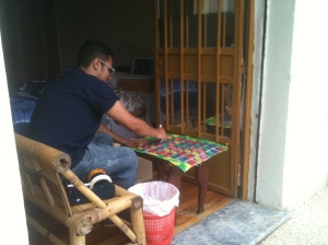Adrian, just inside his balcony, making Condom Art Pins